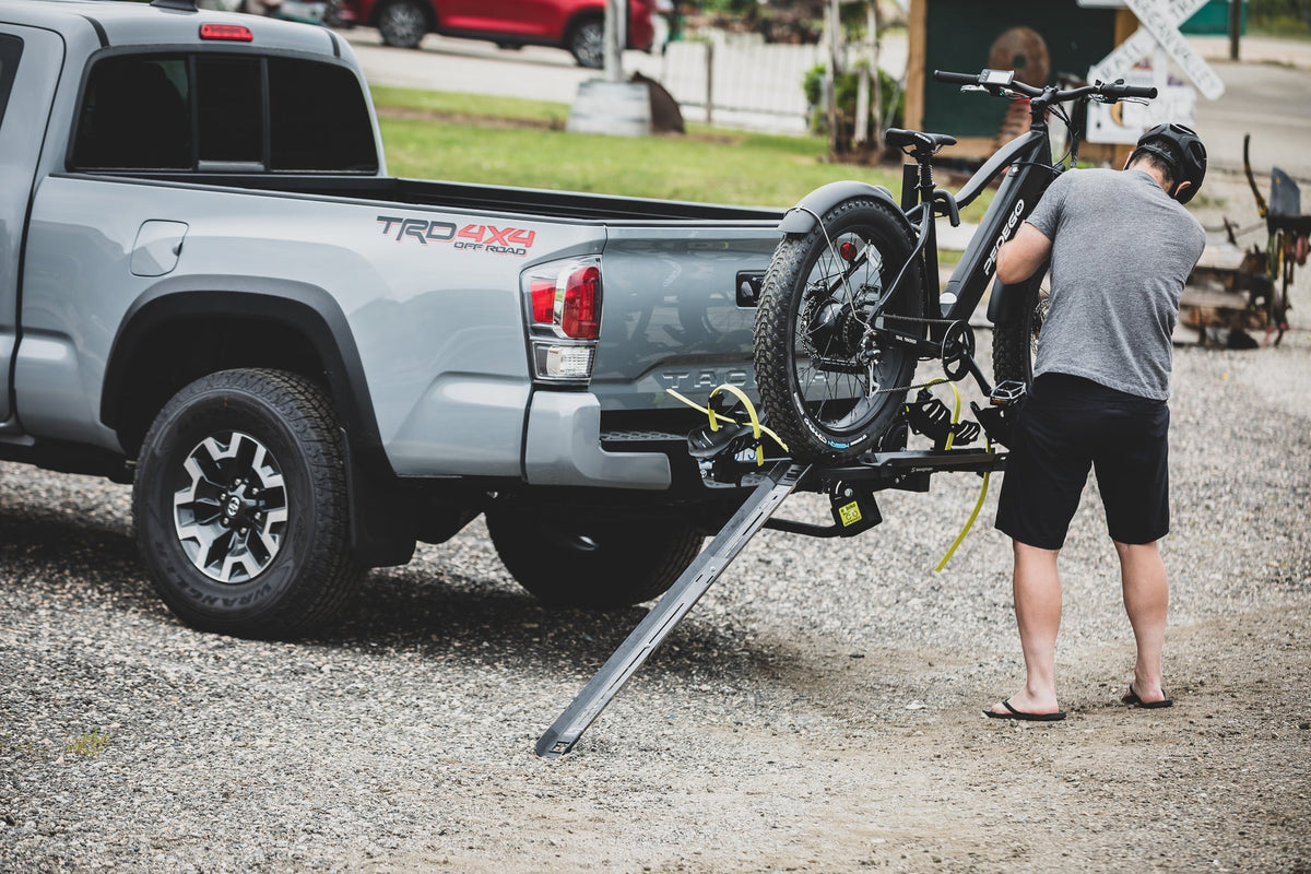 Rider loading a bike onto a Swagman rack using the ramp