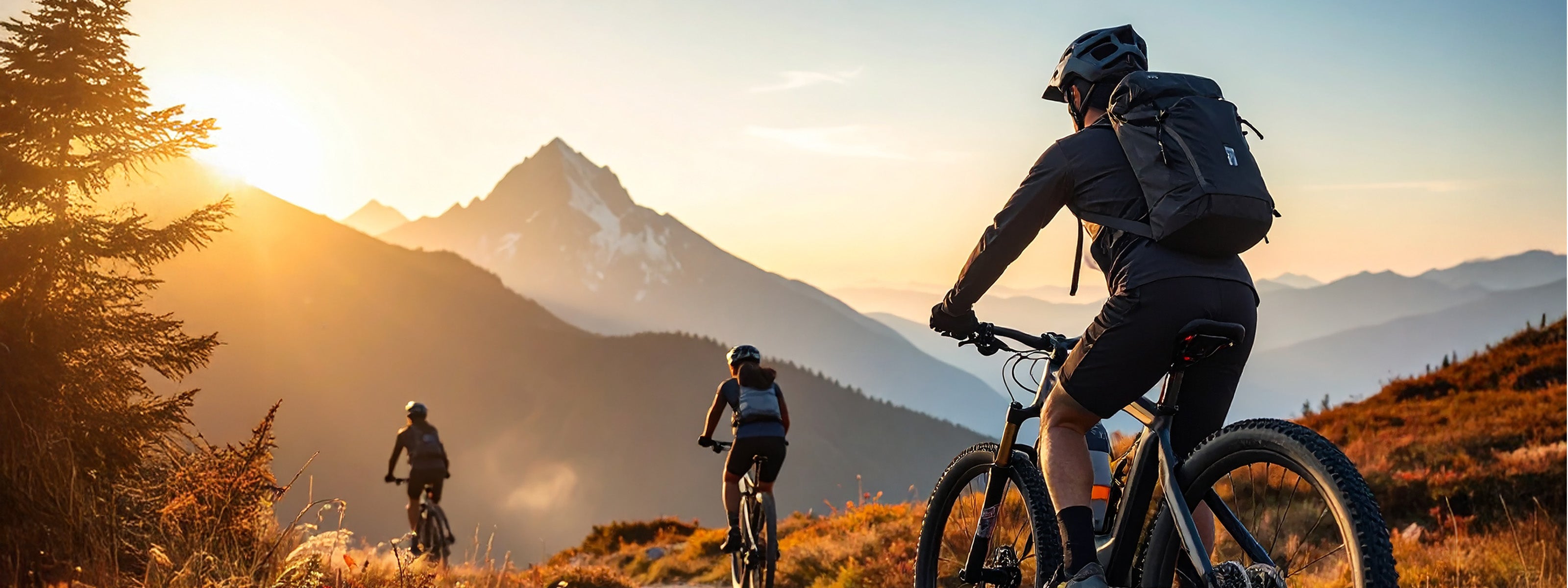 Ride Forge Co. electric mountain bike riders on a high-alpine trail at sunset