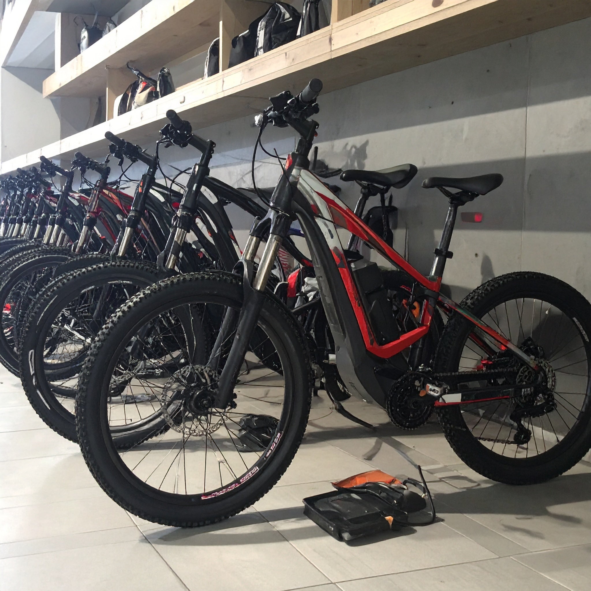 Row of electric bikes in a store with shelves above